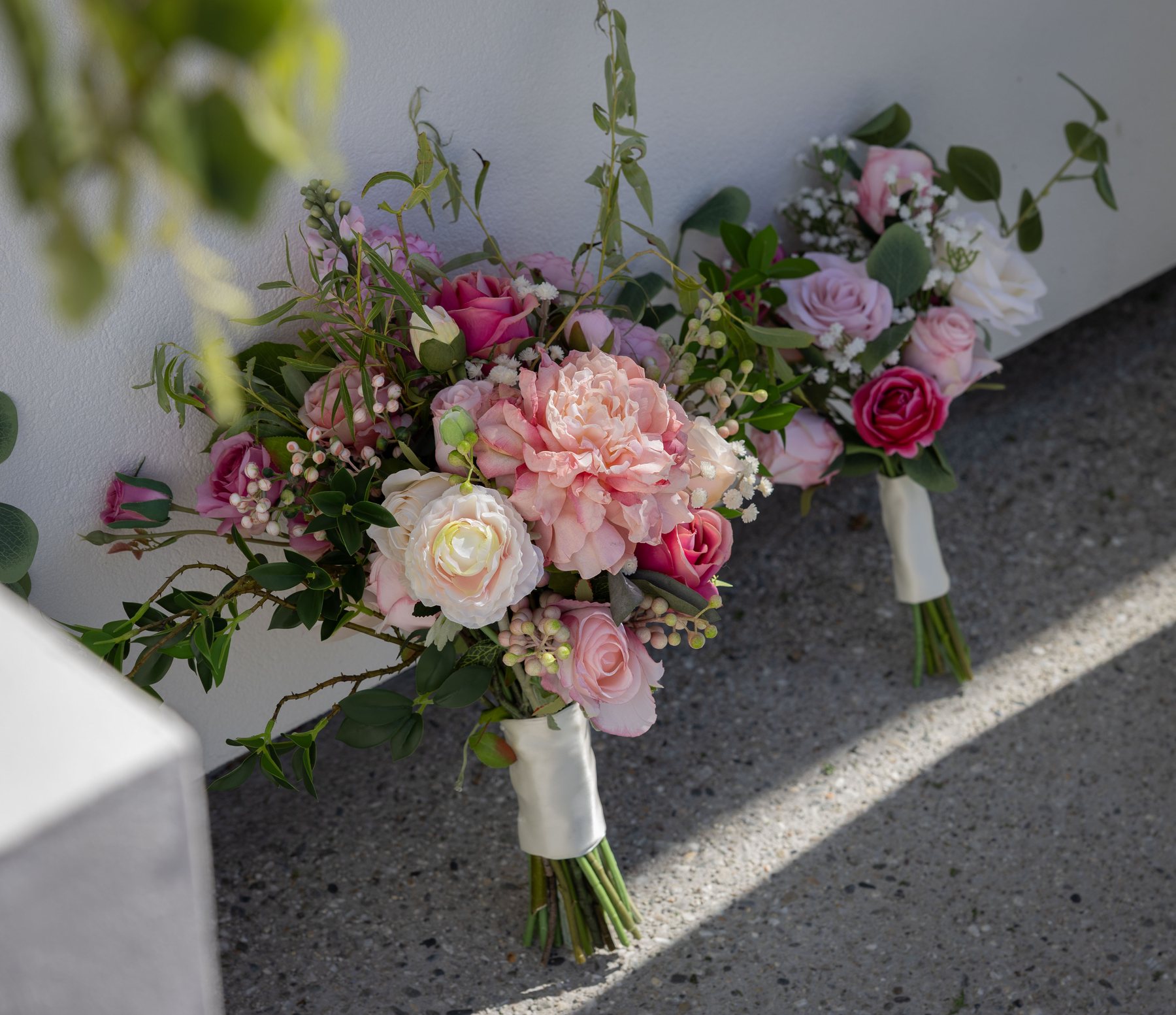 Bridal and bridesmaid bouquets side by side